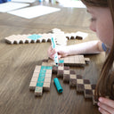 Child coloring cardboard sword