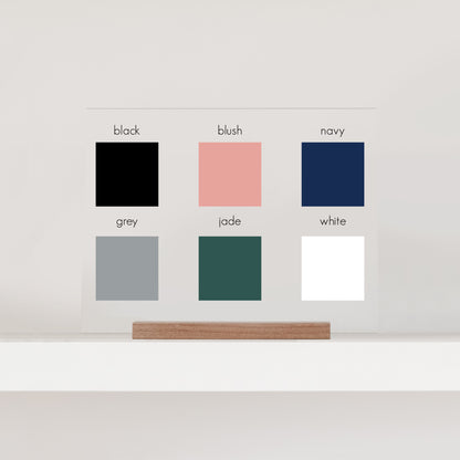 An image showcasing the six available color options: black, blush, navy, grey, jade, and white.